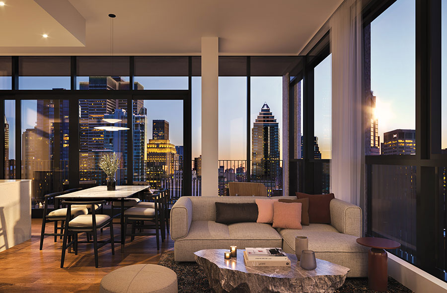 Penthouse living room with large windows overlooking downtown Montreal